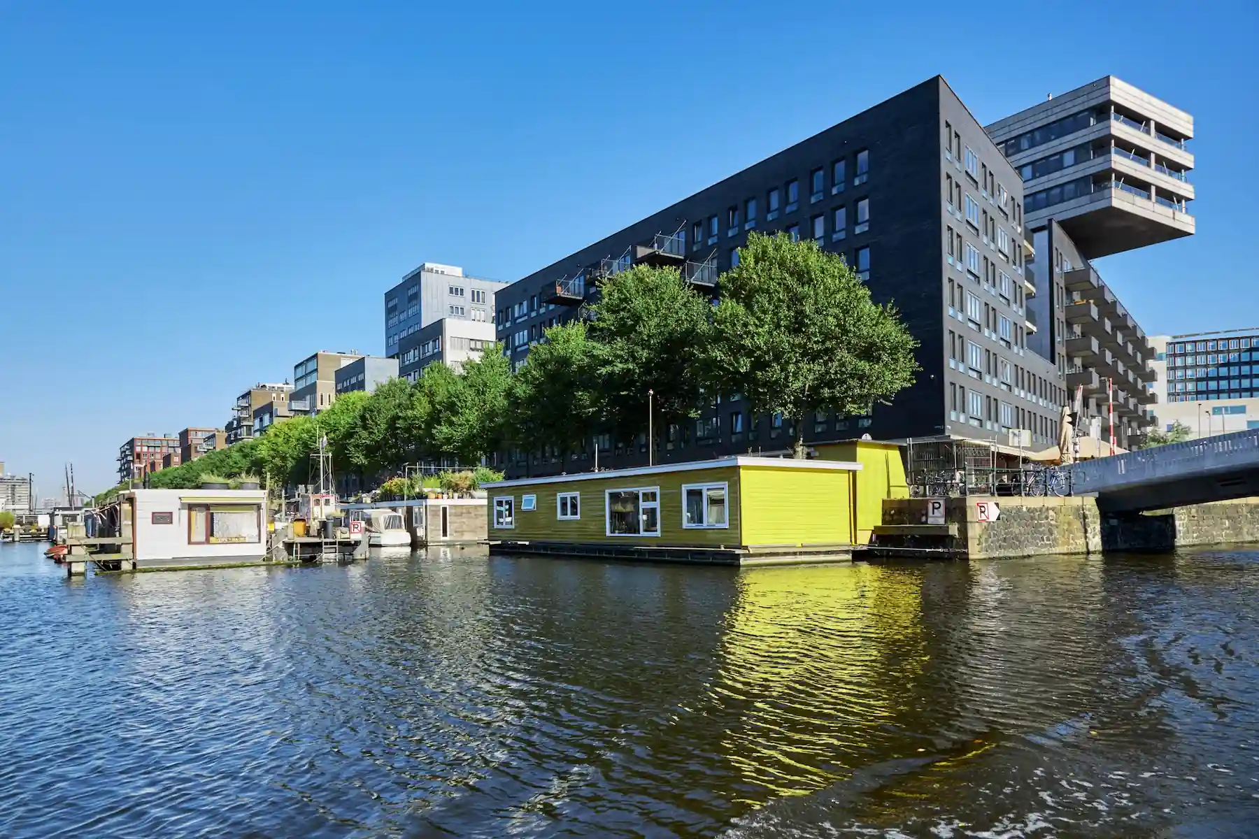 Modern architecture and houseboats at Westerdok in Amsterdam
